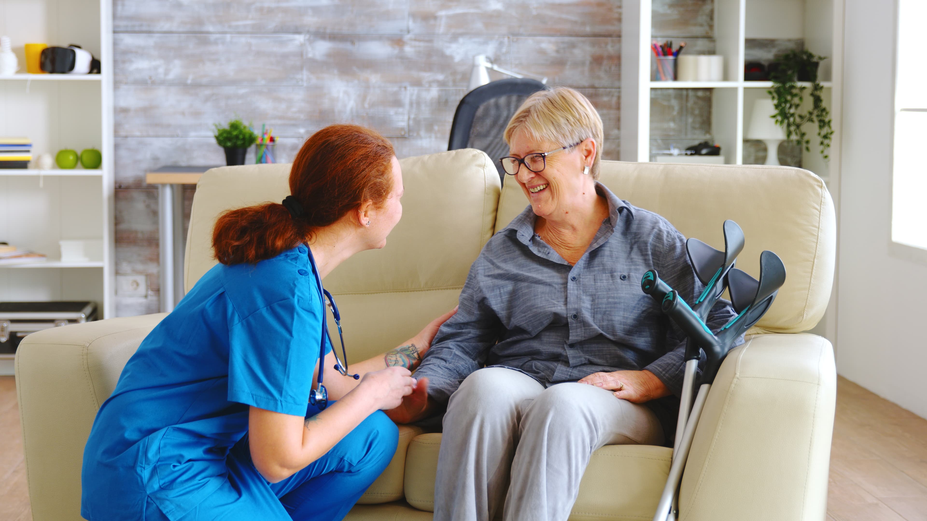 Caregiver supporting senior client walking with walker